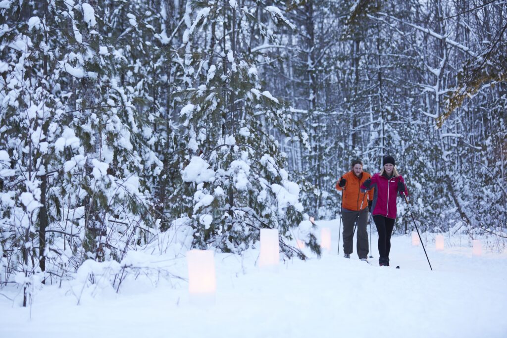 Two people cross country skiing at dusk in Door County, Wisconsin, United States