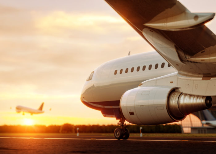 Airplane on tarmac at sunset