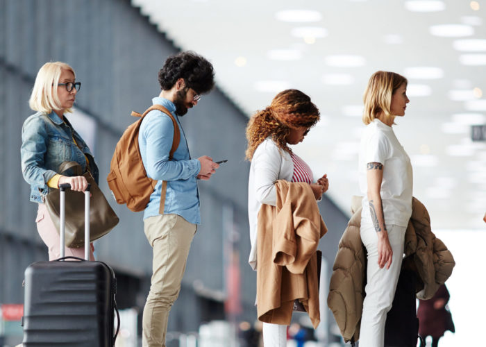 People waiting in security line at airport