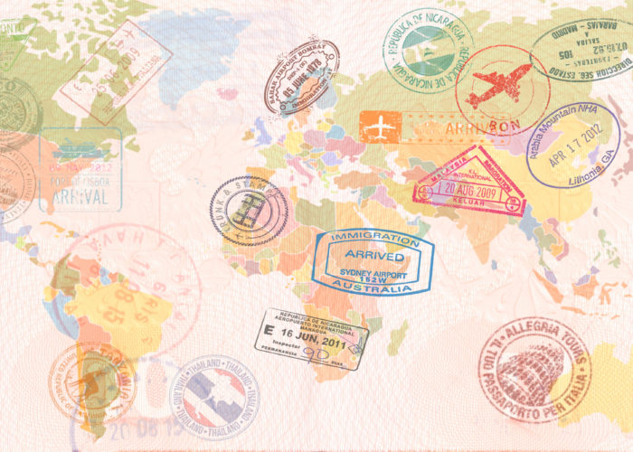 World map covered in passport stamps