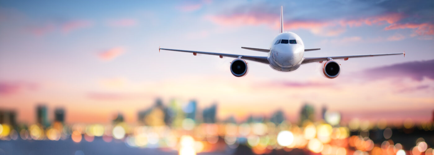 Airplane landing on runway at dusk