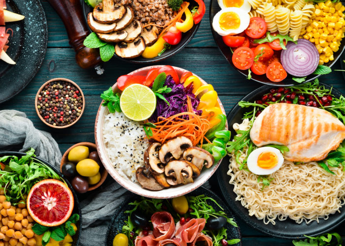 Assortment of healthy foods laid out on black wooden table