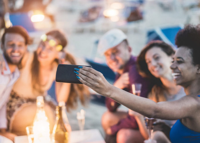 Friend taking selfies at the beach