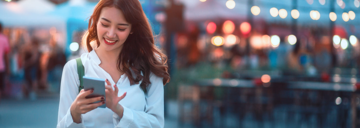 Woman using her phone at outdoor market