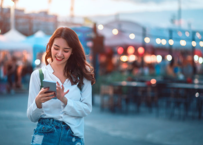 Woman using her phone at outdoor market