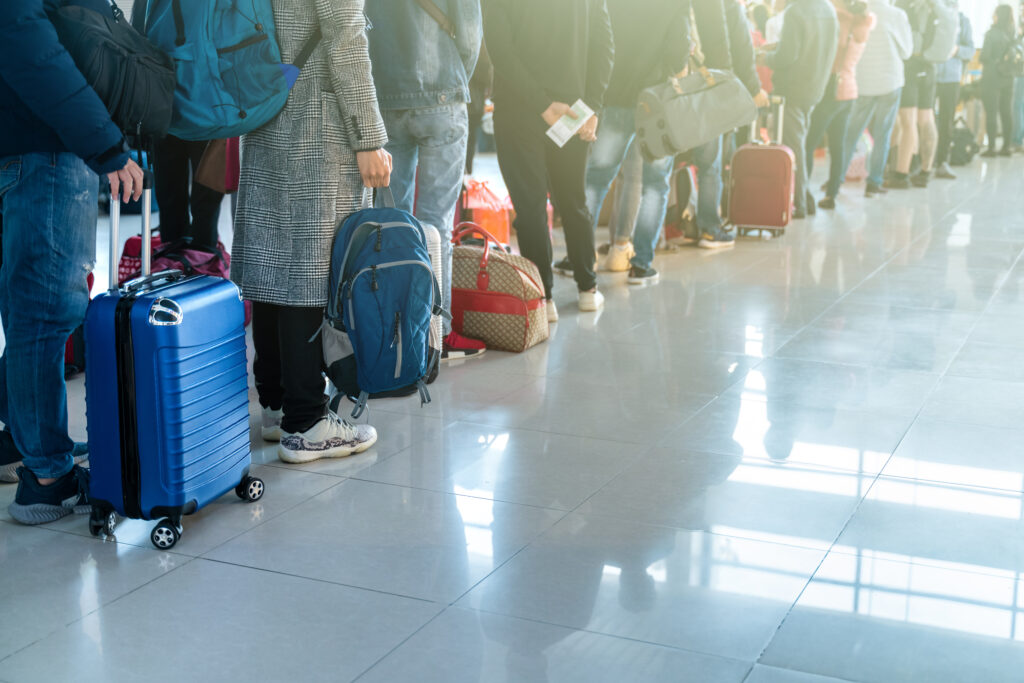 People waiting in line at busy airport