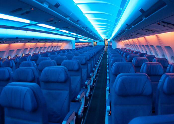 Empty airplane cabin with lights dimmed