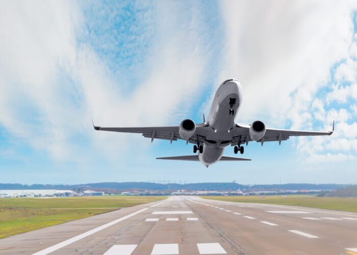 Passenger plane taking off runway on a clear day