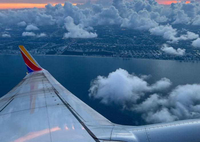 Wing of Southwest Airlines plane as seen from the window of the plane at sunset