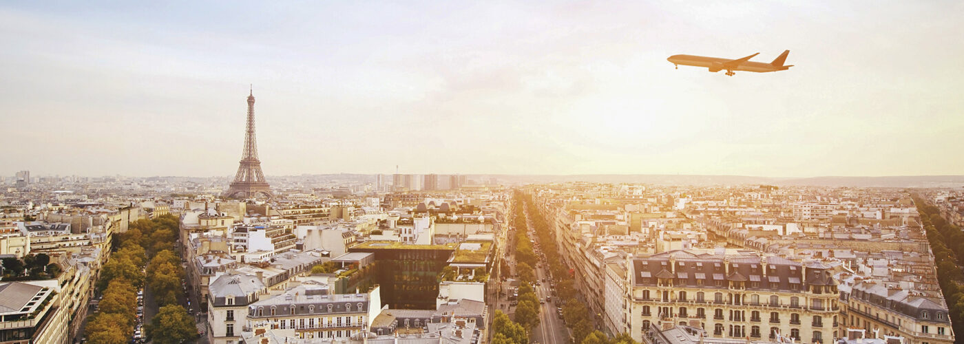 airplane flying over eiffel tower in paris france