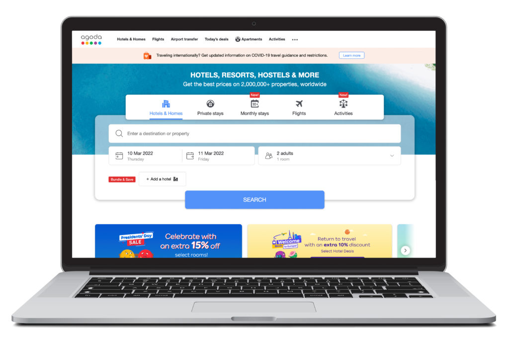 Open laptop showing home screen of Agoda, one of many listed hotel reservation sites