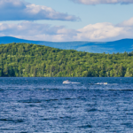 Boats on Lake Winni with the mountains in the background during the summer.